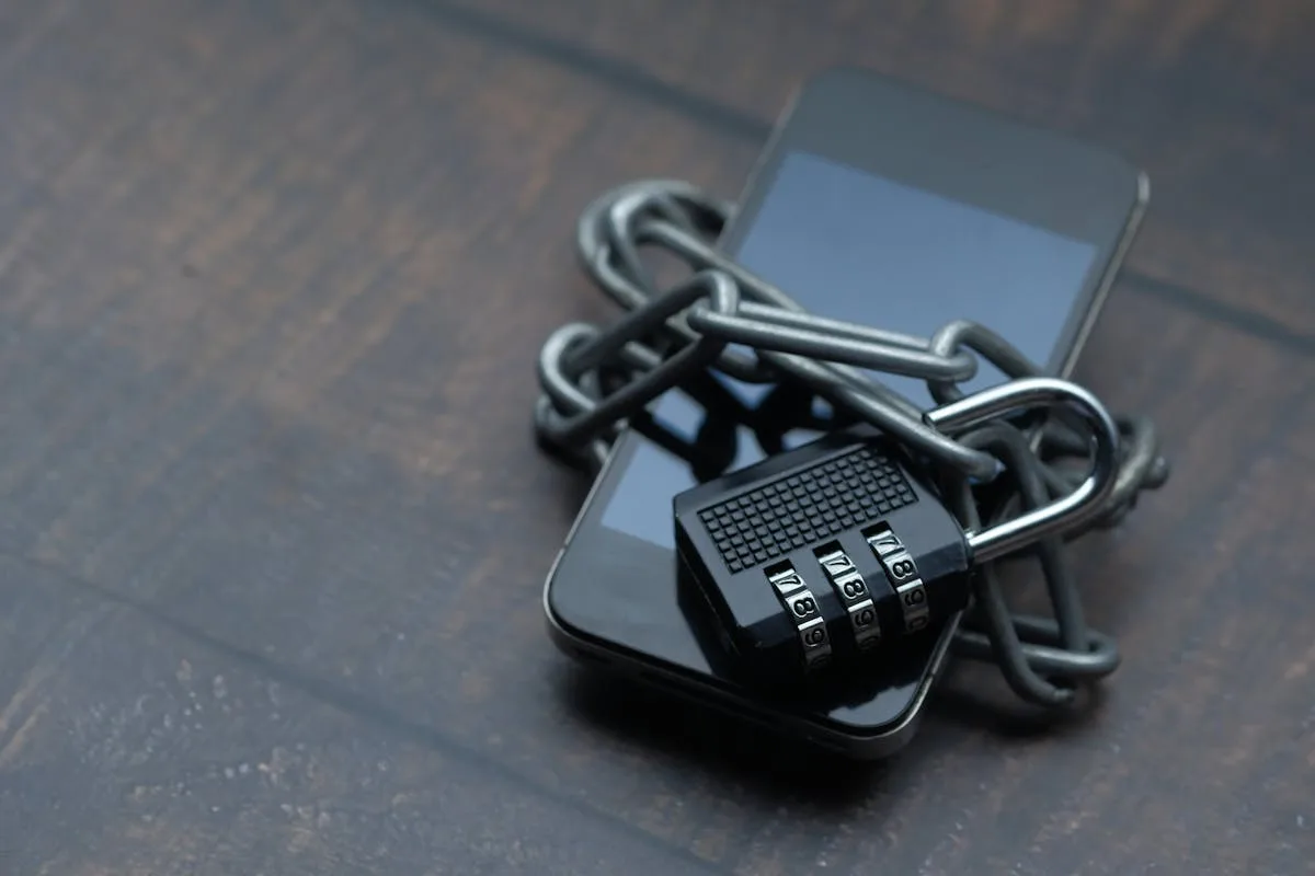 Smartphone locked with chain and padlock — protecting photo GPS metadata privacy